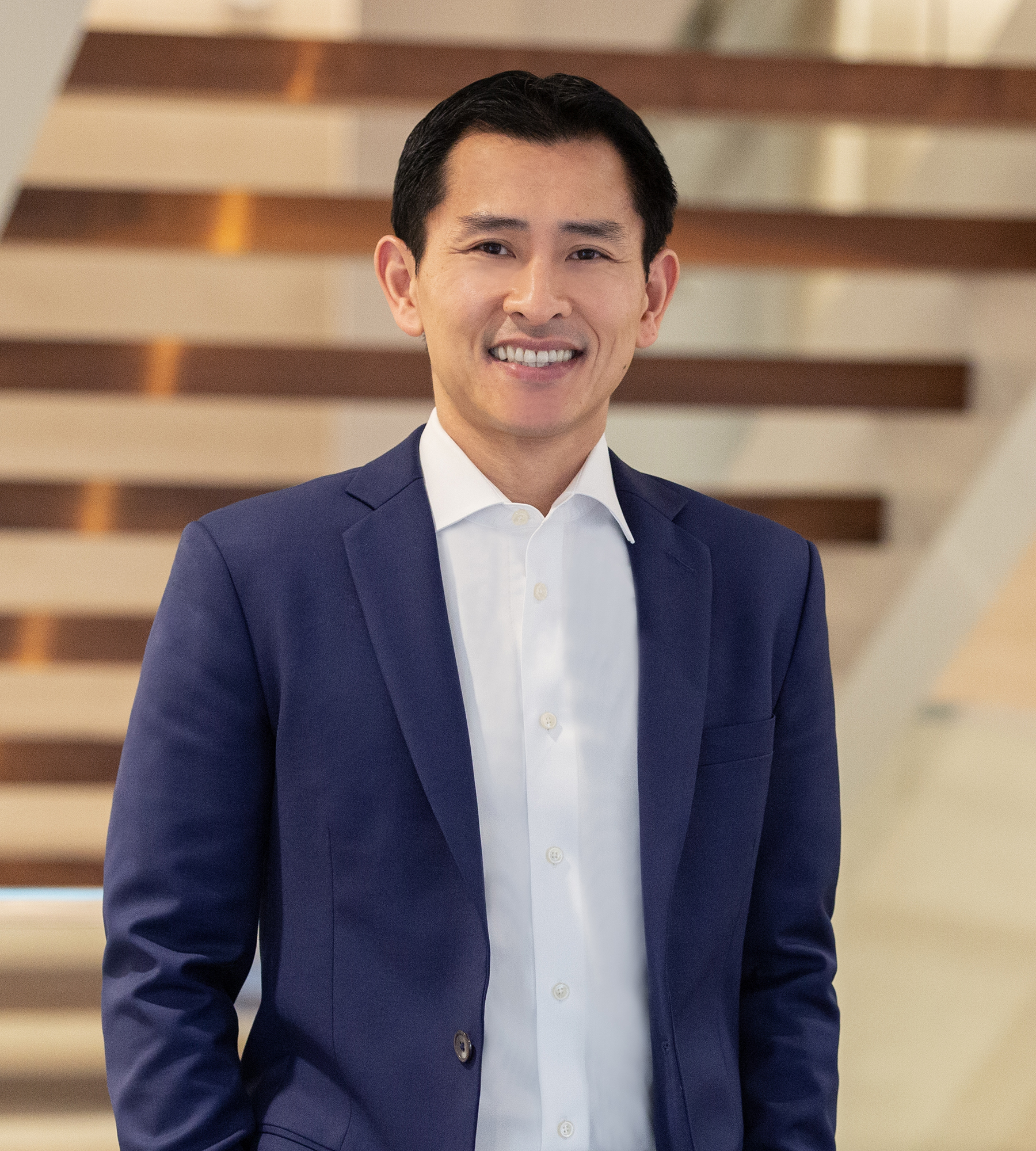 Photo of Josh Hsu standing in an office