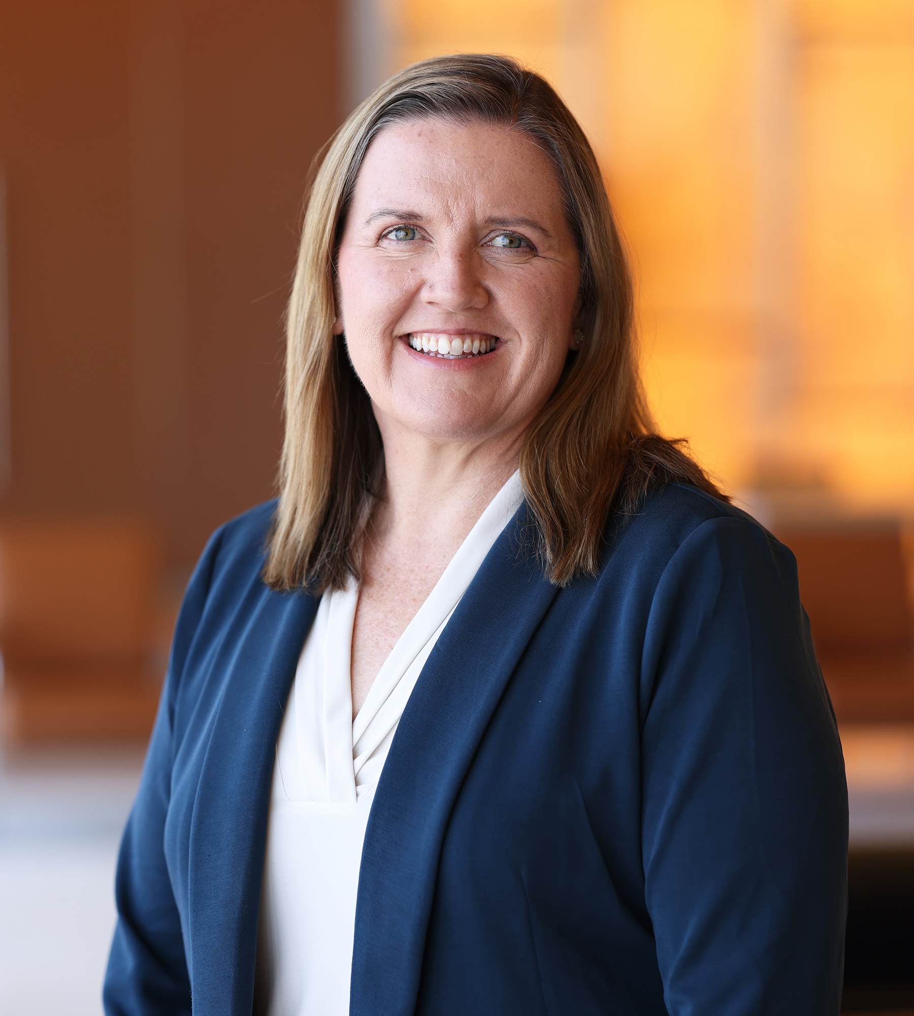 Photo of Mary Maher standing in an office