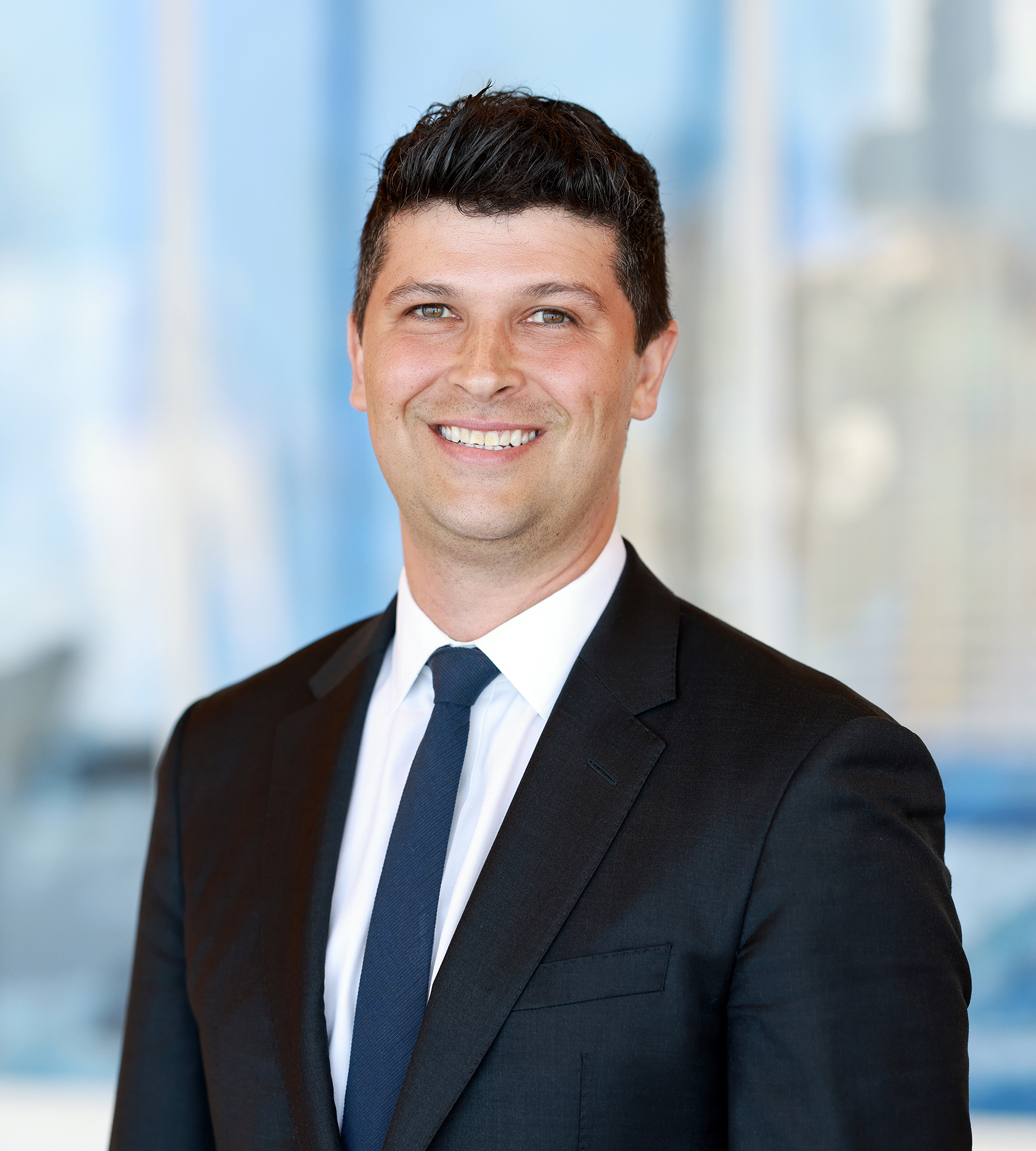 Photo of Andrew Csoros standing in an office