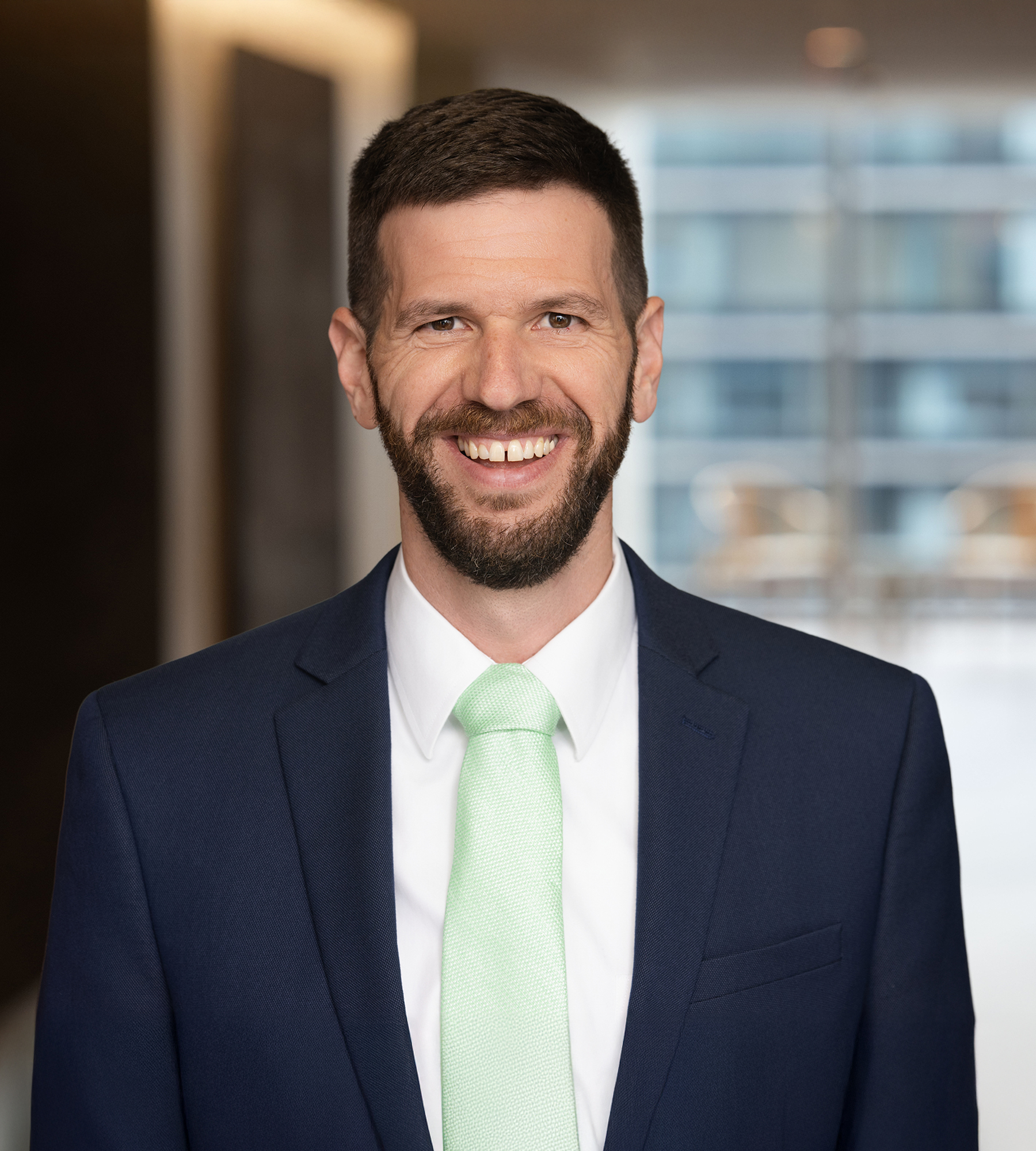 Photo of Daniel Schwei standing in an office