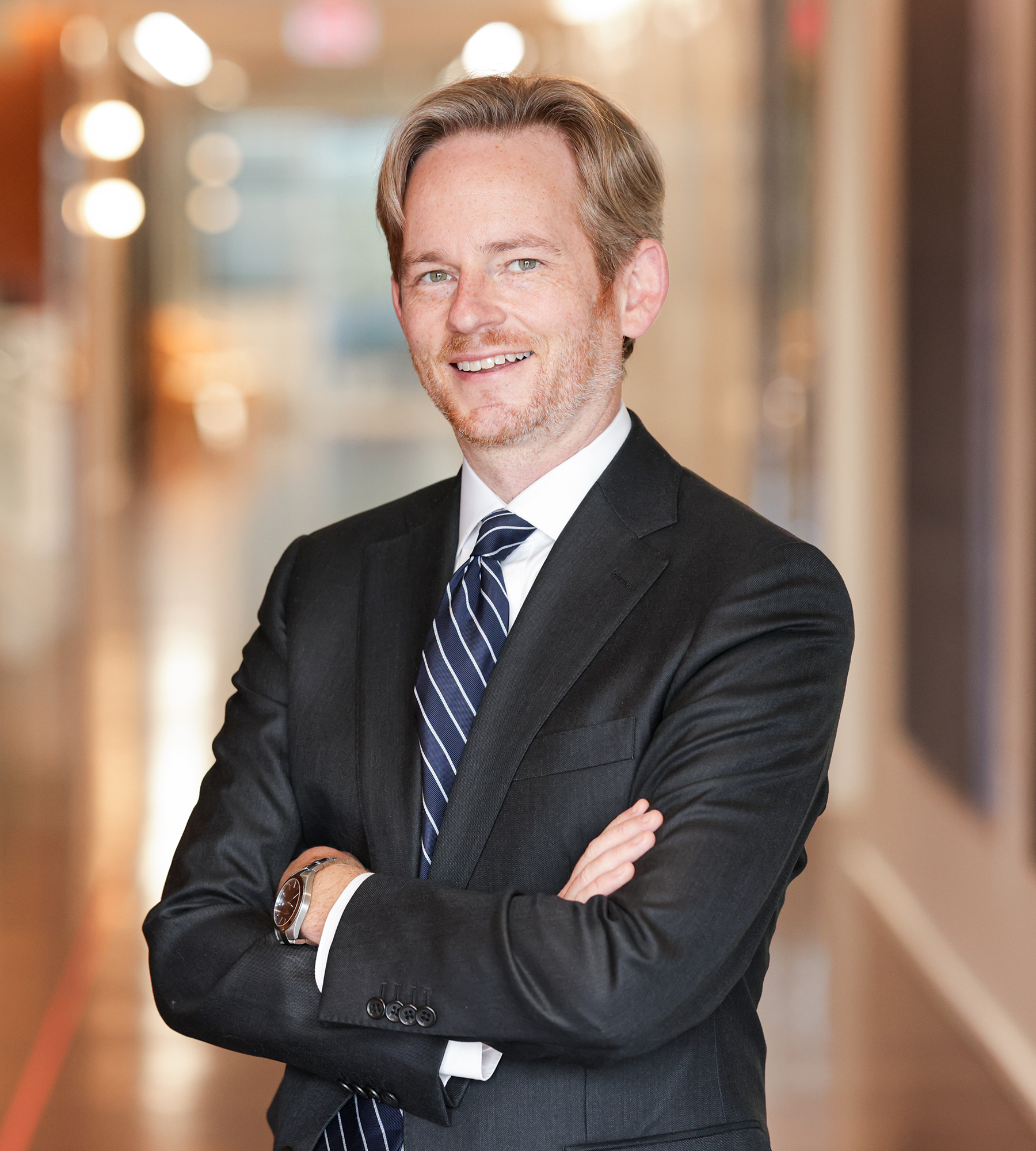 Photo of Zachary Schauf standing in an office